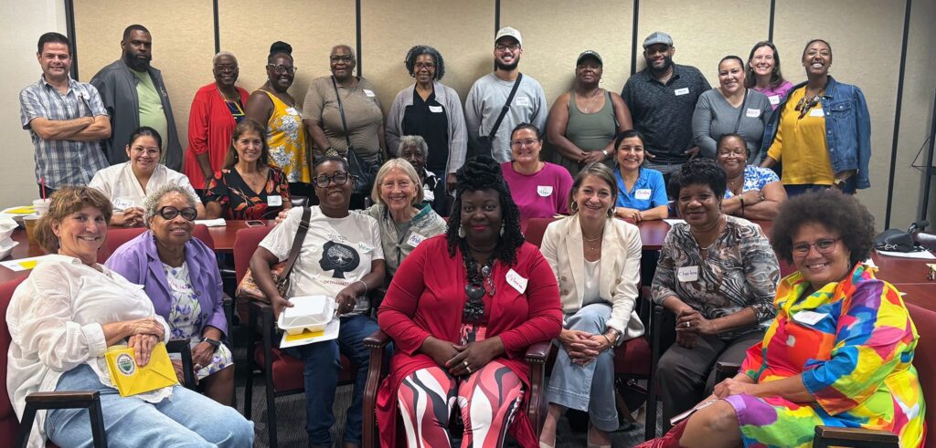 Diverse group of people at a school boatrd meeting posing for a picture