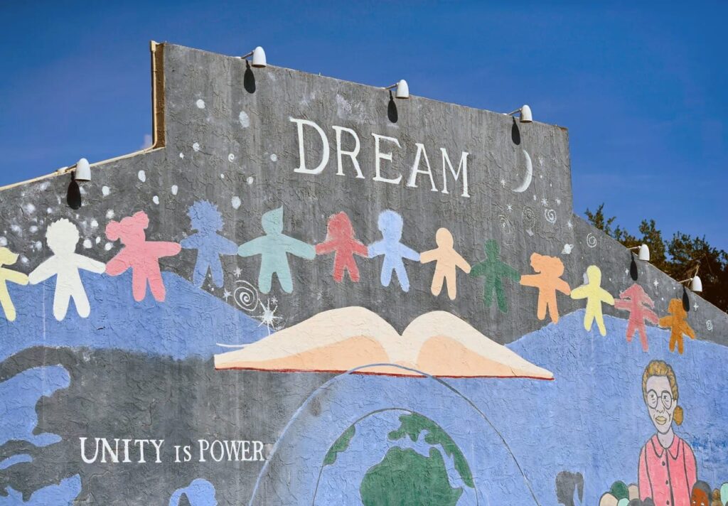 Mural on the side of a building that says "Dream"